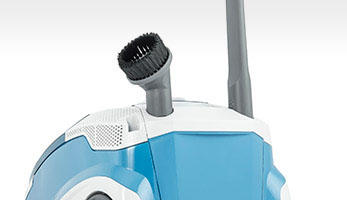 Mistral XS, convenient slots on the vacuum cleaner body for upholstery and crevice nozzles